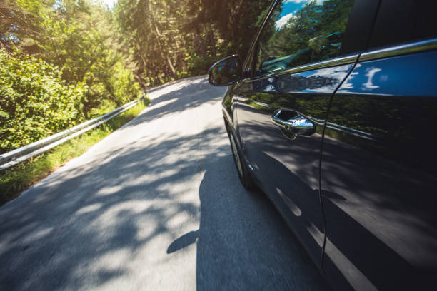 istock Driving car along the highway through pine forests at sunny day 1399353770