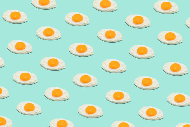 istock Seamless creative food pattern. Fried eggs on a blue background. Funny colorful breakfast concept. 1399353946