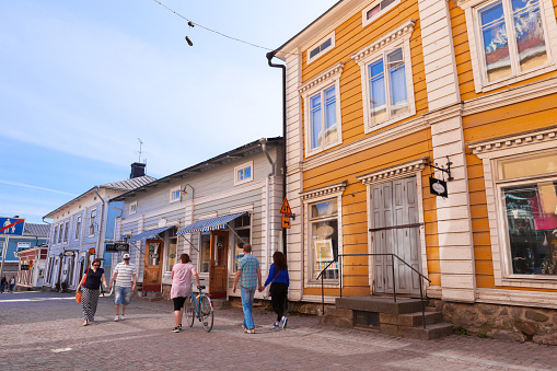 Porvoo, Finland - July 5, 2015: Porvoo old town street view with small shops and old residential houses, ordinary people walk the street