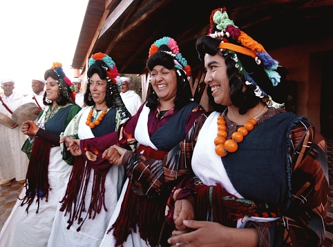 Dades-Morocco, September 25, 2013: Moroccan women dancing and laughing in folkloric traditional costumes.