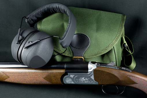 Shotgun with hearing protectors and cartridge bag