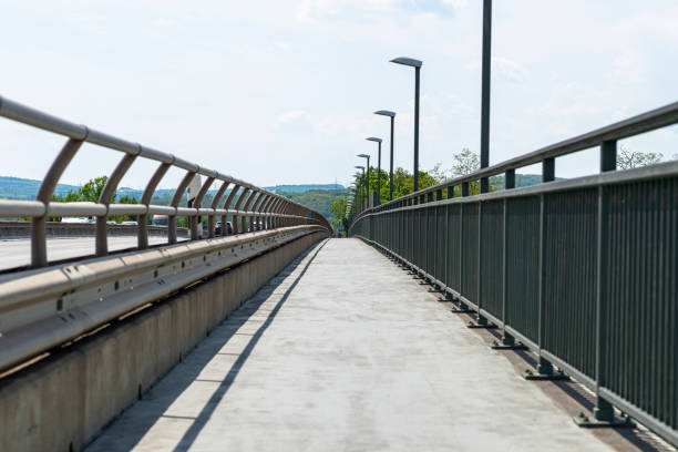 istock Pedestrian crossing on the highway bridge over the river in West Germany, an empty pavement visible. 1399359449