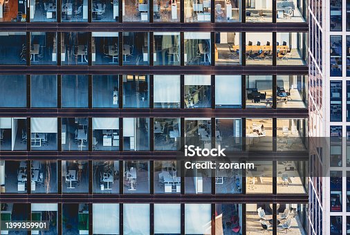 istock Corporate building facade in windows of glass and steel 1399359901