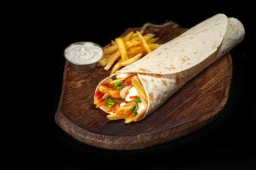 shawarma vegetable and french fries on wooden tray, doner kebab burrito filling burrito veggie pita, copy space, food background, veganism food, close up