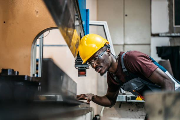 istock Afro american worker using machine in faktory 1399360815