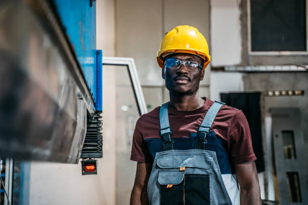 istock Afro american worker using machine in faktory 1399360816