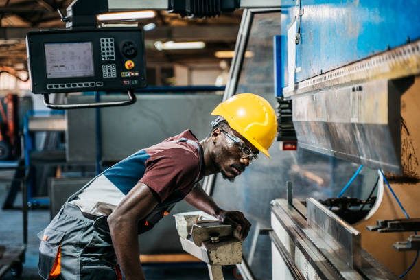 istock Afro american worker using machine in faktory 1399360822