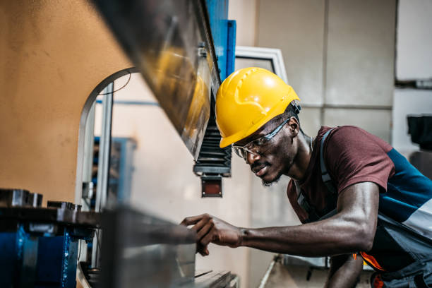 istock Afro american worker using machine in faktory 1399360872