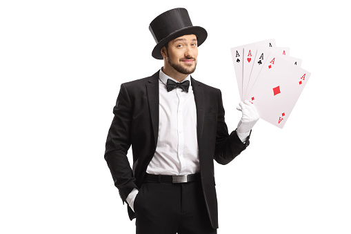 Magician showing four aces isolated on white background