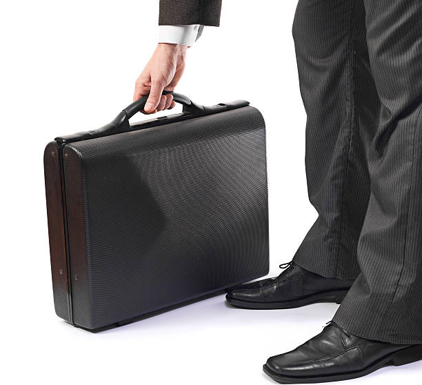 istock Elegant business man in suit holding black briefcase 139936322