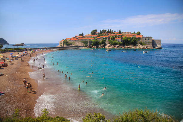 Sveti Stefan Formerly an island, Sveti Stefan was connected to the mainland by a narrow isthmus. Today it's old stone houses are luxurious suites for high class guests from around the world. It is located few kilometres from Budva, Montenegro. budva stock pictures, royalty-free photos & images