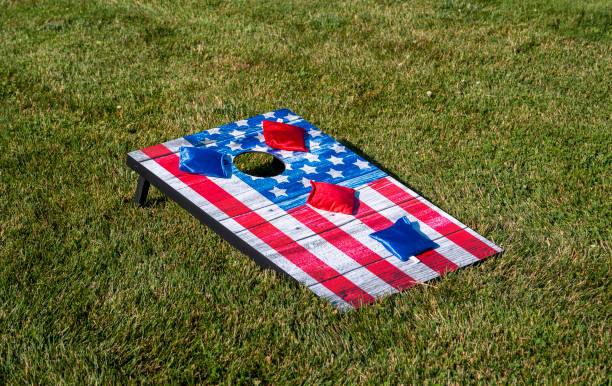 赤と青のビーンバッグとアメリカの旗コーンホールゲーム - cornhole leisure games outdoors color image ストックフォトと画像