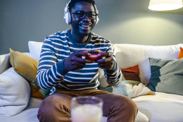 istock Excited young man playing video games 1399370674
