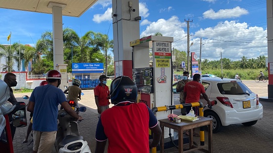 Negombo, Sri Lanka – April 13, 2022: Vehicles queuing in a long line at a gas station during the economic crisis of Sri Lanka.