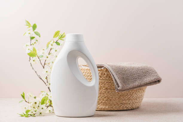 Eco-friendly washing white bottle and Clean towel in wicker basket stock photo