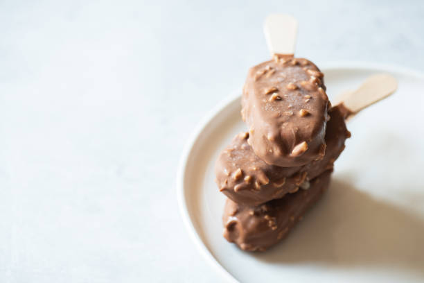 istock Almond chocolate ice-cream on a stick. Close up. 1399371840