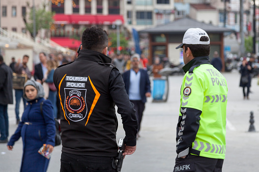 Italian police squad patrol formation back view with Local Police logo emblem on uniform maintain public order in the streets of Venice, Venezia, Italy, Italia