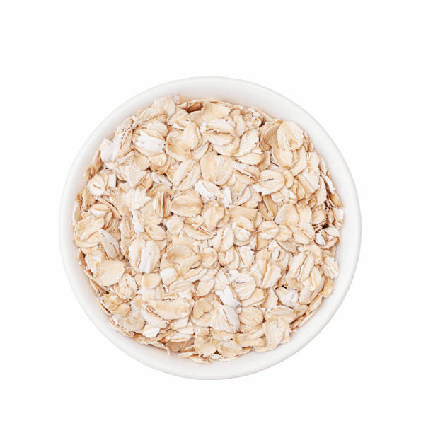 istock Oat flakes in white cup top view isolated on white background 1399373930