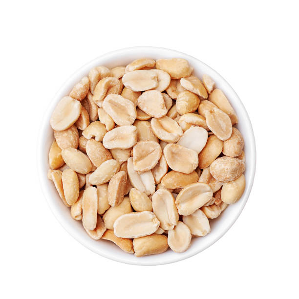 istock Roasted peanuts in a white cup, top view on a white background 1399374017