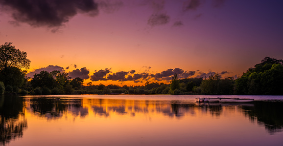 Golden Sunset over lake with boats and reflection