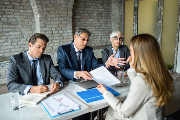 Human resource team rejecting young female candidate on a job interview. stock photo