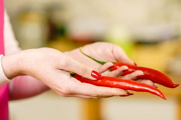 istock Woman holding chilli hot pepper 1399381141