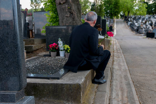 istock Mature man mourning a deceased loved one on cemetery. 1399381158