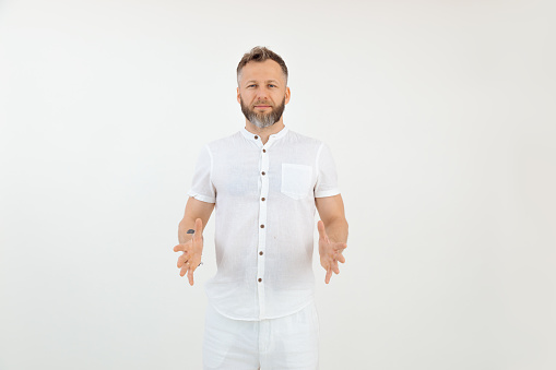 Handsome friendly businessman in white outfit on isolated background. Showing and holding invisible box. Empty template space for advertise, mock up. Successful lucky male, love job. Copy space