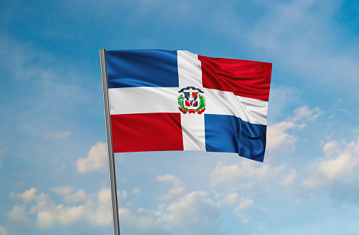 Dominican Republic national flag waving in the wind. Sky background 3D illustration