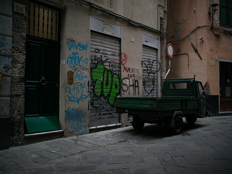 Genoa, Italy - May 22, 2022: delivery van parked in an alley of Genoa