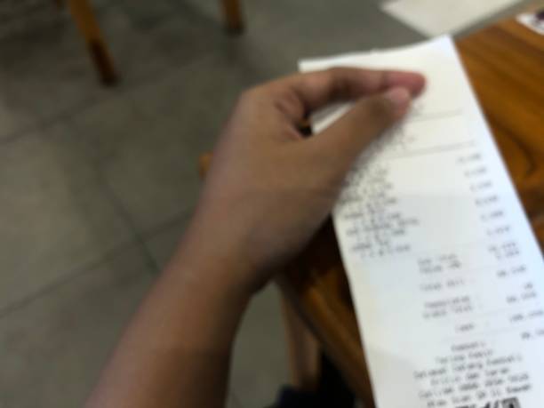 istock hand held shopping receipt blur photo 1399387519