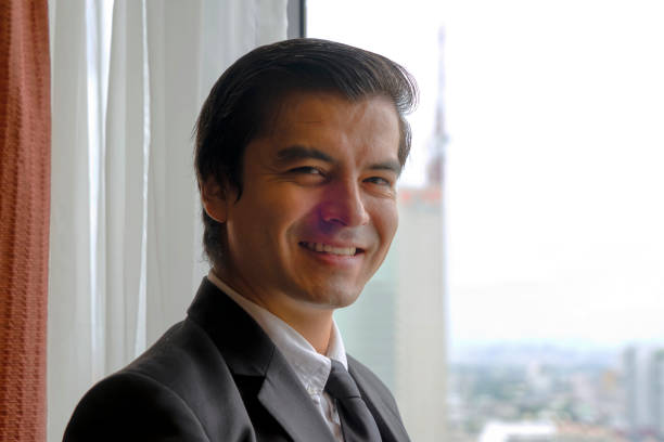 Business man is working at hotel room. City view intown. Business and Travel concept.