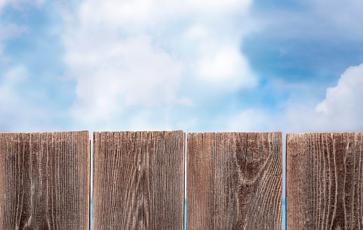 Wooden fence sky clouds. Natural background. Free space