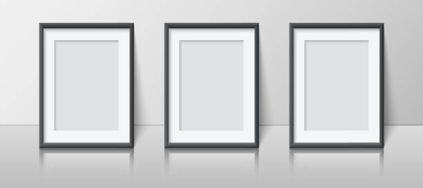 istock Realistic vertical blank picture frame set stands near the wall on the shelf. Three empty photo frame mockup with reflection for pictures, photograph, poster 1399390552