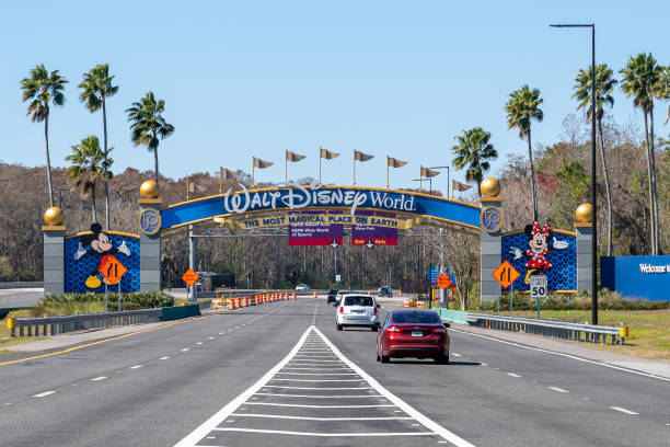 A Walt Disney World arch gate on the road in Orlando, Florida, USA. Orlando, Florida, USA - February 9, 2022:  A Walt Disney World arch gate on the road in Orlando, Florida, USA. Walt Disney World is an entertainment resort complex. disney world stock pictures, royalty-free photos & images