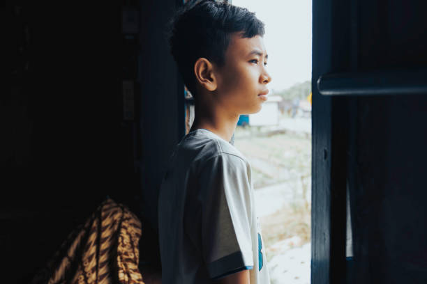 istock Boy On Window Of House 1399394561