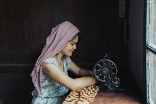 istock Female fashion designer using sewing machine in home 1399394623