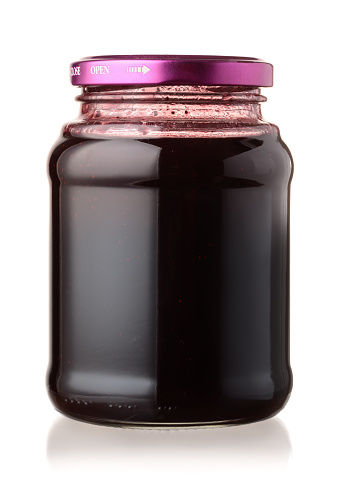 Jar of  blackberry jam isolated on white