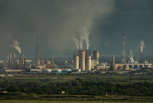 Oil and gas refinery plant with chimney smoke, Business petrochemical industrial, power and fuel energy, Ecosystem and healthy environment concepts\