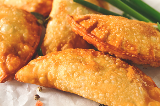 Fried chebureks, close-up, on a light background, no people,