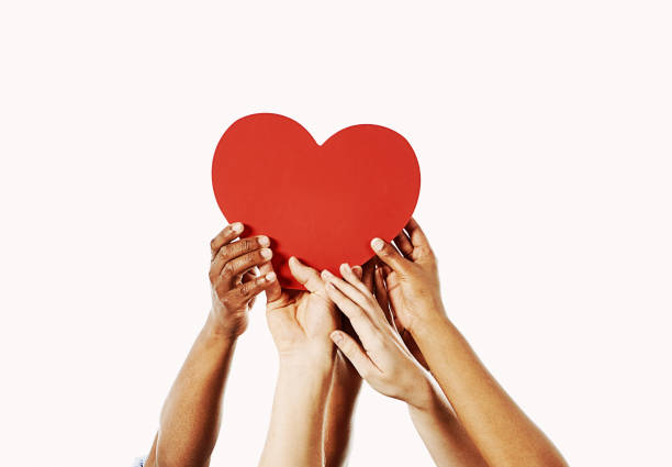 love; beautiful hands of children holding green heart shape