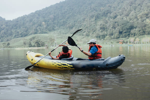 istock young boy and his father enjoy lake kayaking 1399399311