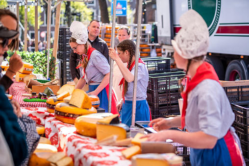 April 22, 2022 - Alkmaar, The Netherlands: women dressed with dutch traditional clothes in  Alkmaar cheese market, Holland, the Netherlands