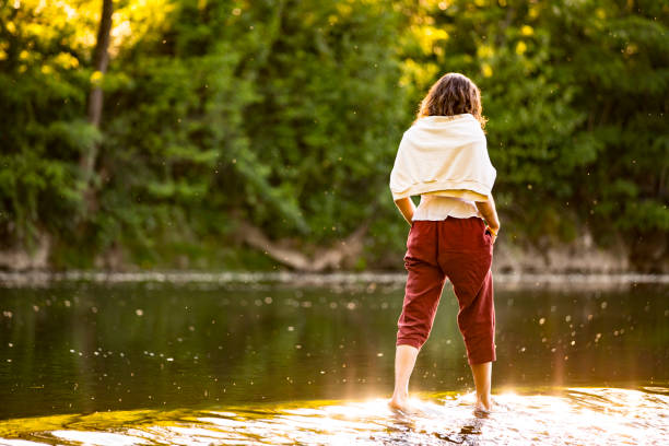 Young Woman Crossing a River.