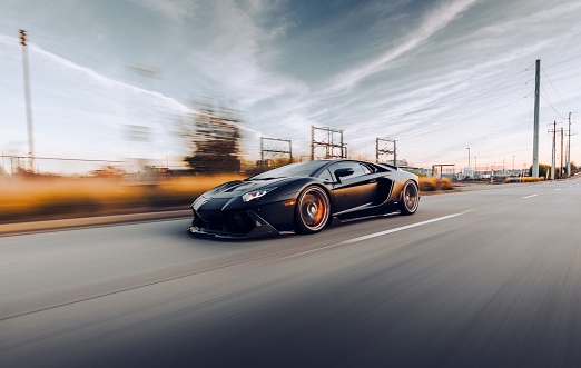 Seattle, WA, USA\n2/2/2022\nBlack Lamborghini Huracan driving on the highway