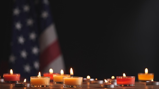 Happy Memorial Day, Lighting memorial candle on American USA flag dark background. Concept of 4th of July, Independence Day, Memorial Day, Veterans Day, Honor, Military, Patriot