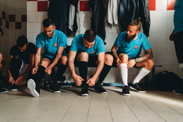 Soccer team players are getting ready in the changing room before the match Soccer team players are getting ready in the changing room before the match. They are dressing. locker room stock pictures, royalty-free photos & images