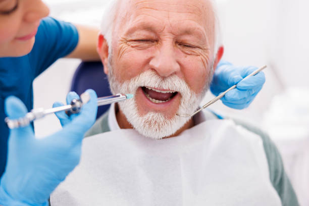 istock Dentist applying local anesthetic 1399402787