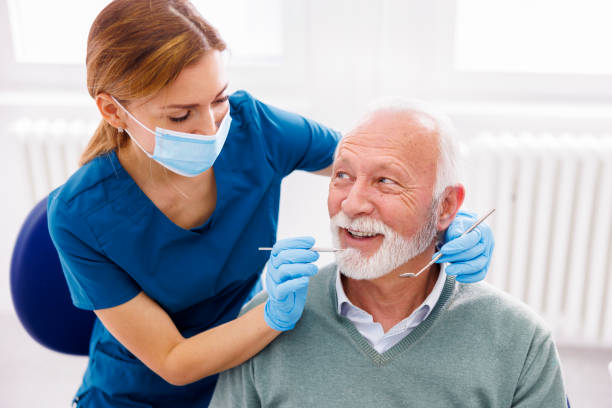Dentist checking up patient at dental clinic stock photo
