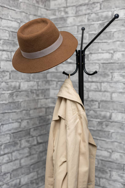 istock a hat and a raincoat hang on a metal floor hanger 1399406018